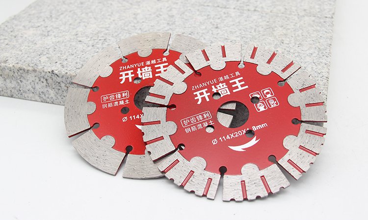 Two red segmented blades beside a concrete block