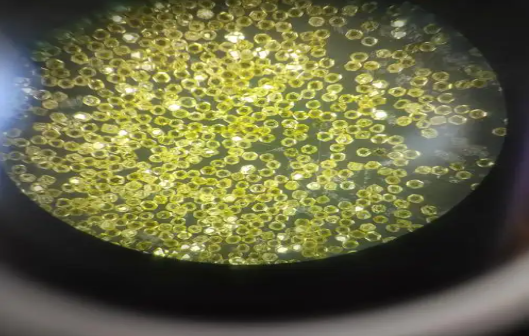 Yellow abrasive grains viewed under magnification