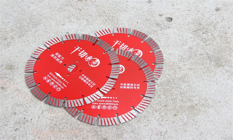 Red diamond blades displayed against a concrete block