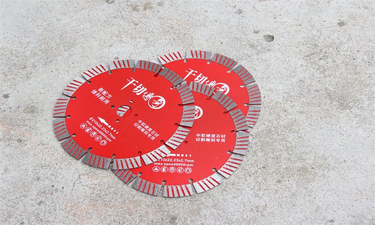 Overlapping red diamond blades beside a concrete block