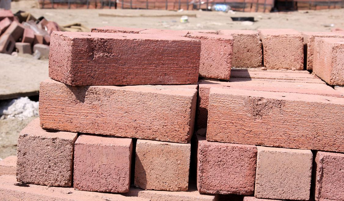 Stacked red masonry bricks