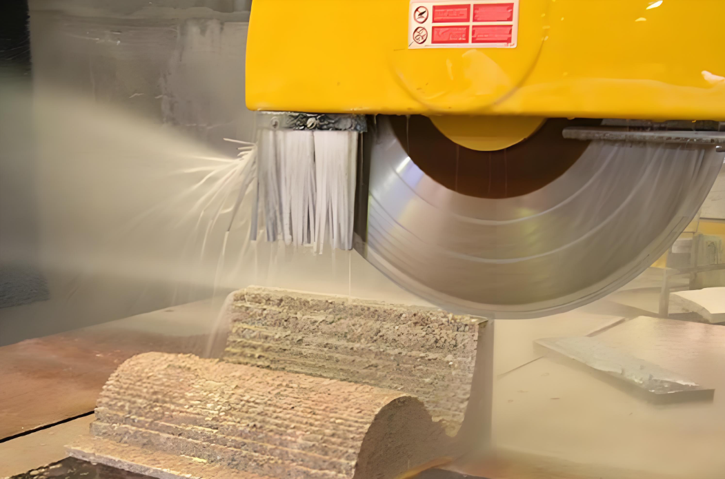 Water-fed stone saw cutting a stone workpiece